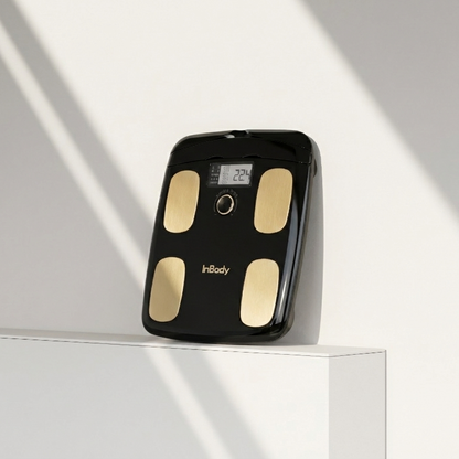 InBodyDial H20 black body fat scale on a white surface with a light gray background