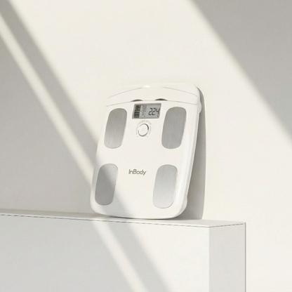 InBodyDial H20 white body fat scale on a light gray surface with soft shadows
